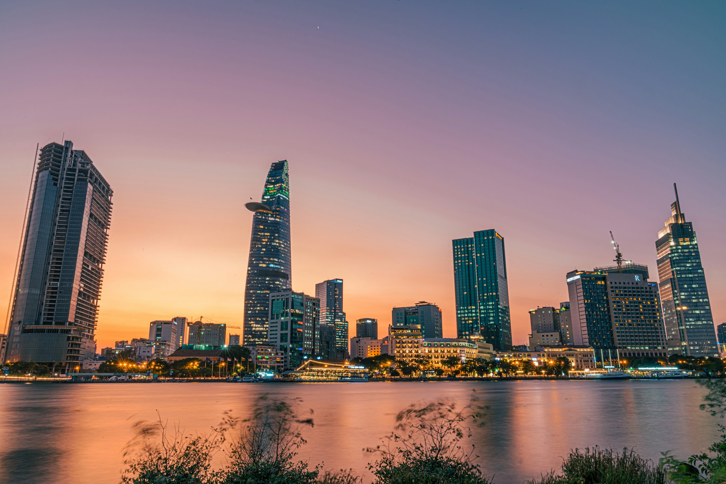 Ho Chi Minh City skyline at sunset with modern skyscrapers and Saigon River